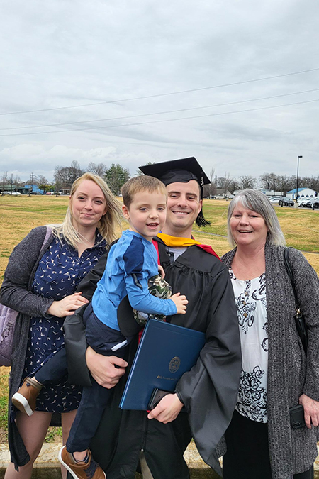Travis Houser, recent graduate of Middle Tennessee State University’s Aeronautical Science master’s program, center right, celebrates his graduation with his family in December 2021 on campus. Standing, from left, are his wife, Amber Houser, his son, Nikola Houser, Houser and his mother, Janine McBee. (Photo courtesy of Travis Houser)