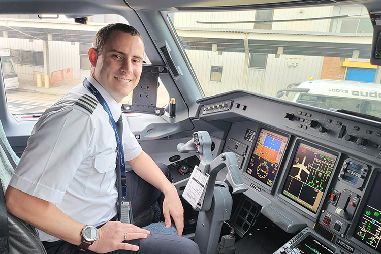 Travis Houser, recent graduate of Middle Tennessee State University’s Aeronautical Science master’s program, sits in the cockpit at Charlotte Douglas International Airport in Charlotte, N.C., on Dec. 24, 2021, after completing his probationary training period as a first officer for Republic Airlines. (Photo courtesy of Travis Houser)