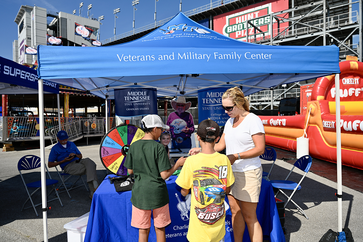 Hilary Miller, right, director of the MTSU Charlie and Hazel Daniels Veterans and Military Family Center, hands out university swag to fans attending the Rackley Roofing 200 NASCAR Camping World Truck Series event Friday, June 24, at the Nashville Superspeedway in Gladeville, Tenn. The Daniels Center has become a partner with both Nashville Superspeedway and Rackley Roofing. (MTSU photo by J. Intintoli)