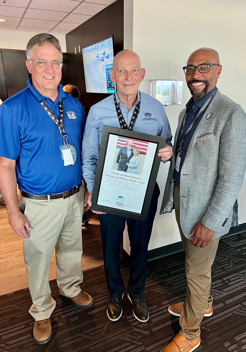 MTSU Provost Mark Byrnes, left, and retired U.S. Army Lt. Gen. Keith M. Huber, center, present Nashville Superspeedway President Erik Moses with a commemorative plaque of Hazel Daniels and her late husband, the legendary Charlie Daniels, Friday, June 24, at the Nashville Superspeedway in Gladeville, Tenn. The presentation occurred before the Rackley Roofing 200 NASCAR Camping World Truck Series event. Huber is senior advisor for veterans and leadership initiatives at MTSU. (MTSU photo by Andrew Oppmann)