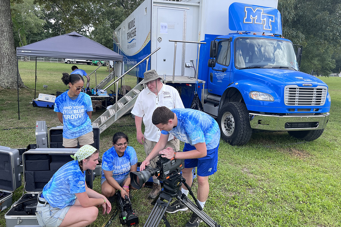 Robert Gordon, second from right, associate professor in MTSU’s Media Arts Department and supervisor of the Mobile Production Lab, helps students Wednesday, June 15, prepare to provide video and streaming services from the university’s Mobile Production Lab, parked in the background behind The Who stage, for upcoming performances at the 2022 Bonnaroo Music and Arts Festival June 16-19 in Manchester, Tenn. (MTSU photo by Andrew Oppmann)
