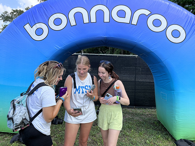 From left, MTSU students Izzy Gutierrez, a sophomore journalism major from Nashville, Tenn.; Rebekah McGuire, a marketing and elementary education junior from Murfreesboro; and MTSU video producer Rachel Byrnes, review video for social media Wednesday, June 15, as part of coverage of the 2022 Bonnaroo Music and Arts Festival June 16-19 in Manchester, Tenn. (MTSU photo by Andrew Oppmann)