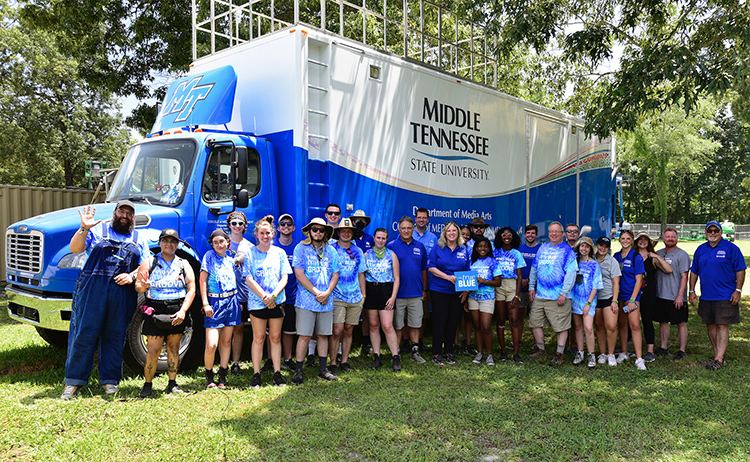 A group of MTSU students, faculty, staff and administrators take a break Friday, June 17, at the 2022 Bonnaroo Music and Arts Festival being held Thursday-Sunday, June 16-19, in Manchester, Tenn. MTSU returned to the festival this year as part of its ongoing partnership with the event to provide College of Media and Entertainment students with real-world experience. The group is standing in front of the university’s $1.4 million Mobile Production Lab, fondly known as “The Truck,” which serves as the home base for the team of MTSU students, faculty and staff providing audiovisual and streaming support of performances as well producing original content at the festival. (MTSU photo by Jonathan Trundle)