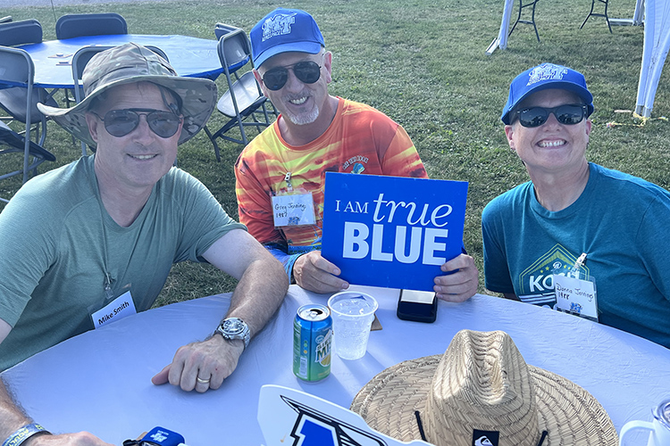 A group of MTSU Aerospace alumni and supporters show their True Blue pride as they enjoy a barbeque reception hosted by the university Wednesday, July 27, at its large tent at the 2022 EAA AirVenture in Oshkosh, Wis. (MTSU photo by Andrew Oppmann)