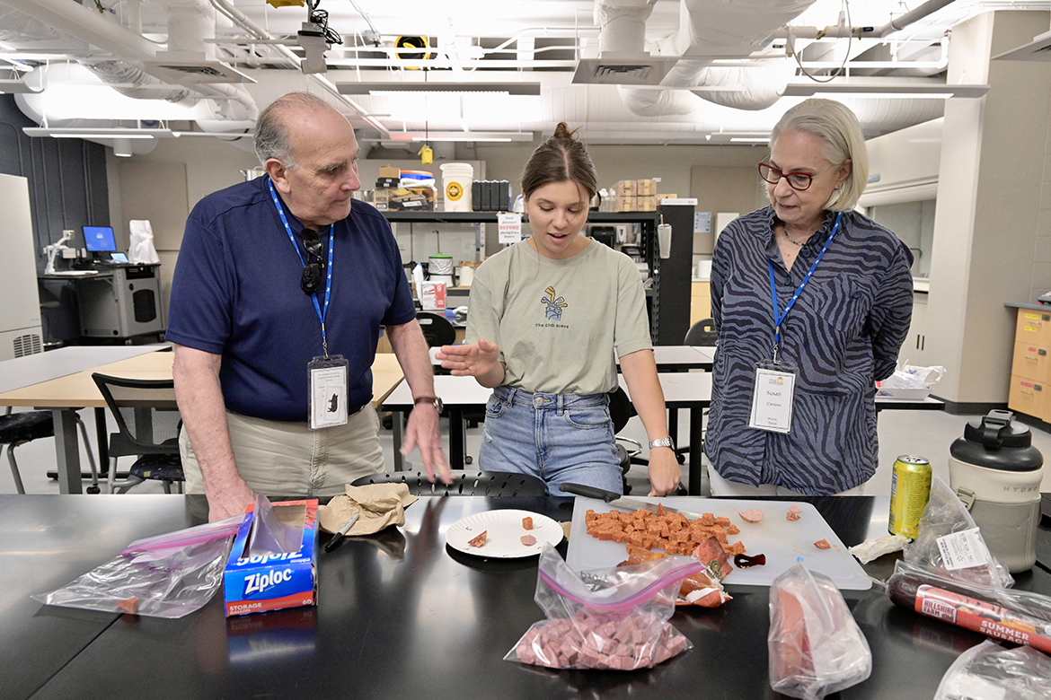 MTSU first-year graduate student Elizabeth Zuy, center, provides a brief demonstration of the fermentation of meats for Alumni Summer College attendees Bob, left, and Susan Cimino of Wylie, Texas. Bob Cimino (Class of 1967) earned a bachelor’s degree, with a double major in math and industrial studies. (MTSU photo by Andy Heidt)