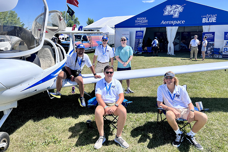MTSU Aerospace Department representatives staff the university’s exhibition tent, which included one of its Diamond training aircraft, this week for the 2022 EAA AirVenture in Oshkosh, Wis. (MTSU photo by Andrew Oppmann)