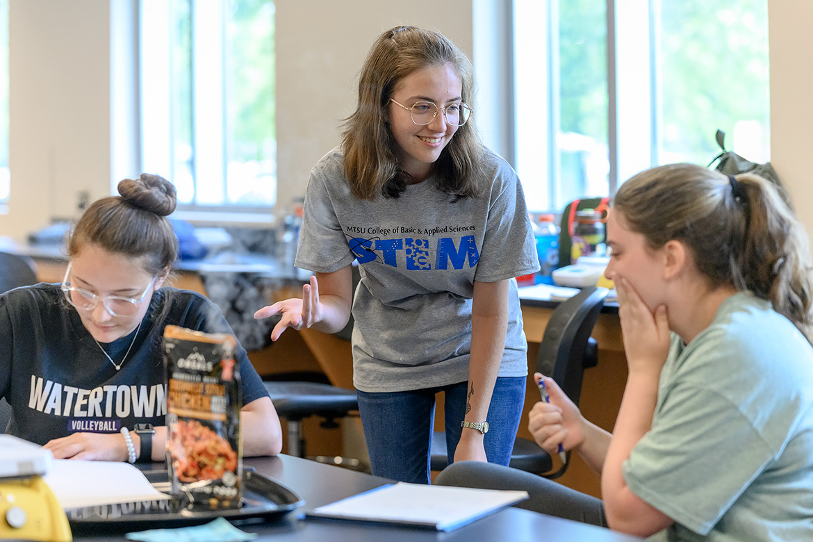 An MTSU student, center, assists two MTSU STEM summer camp participants with their chemistry project during the July 2022 College of Basic and Applied Sciences inaugural event for rising sophomores and juniors in a Science Building classroom. The college will hold the event June 19-23, with registration opening Wednesday, March 15, and expanding to 90 students this year. (MTSU file photo by J. Intintoli)