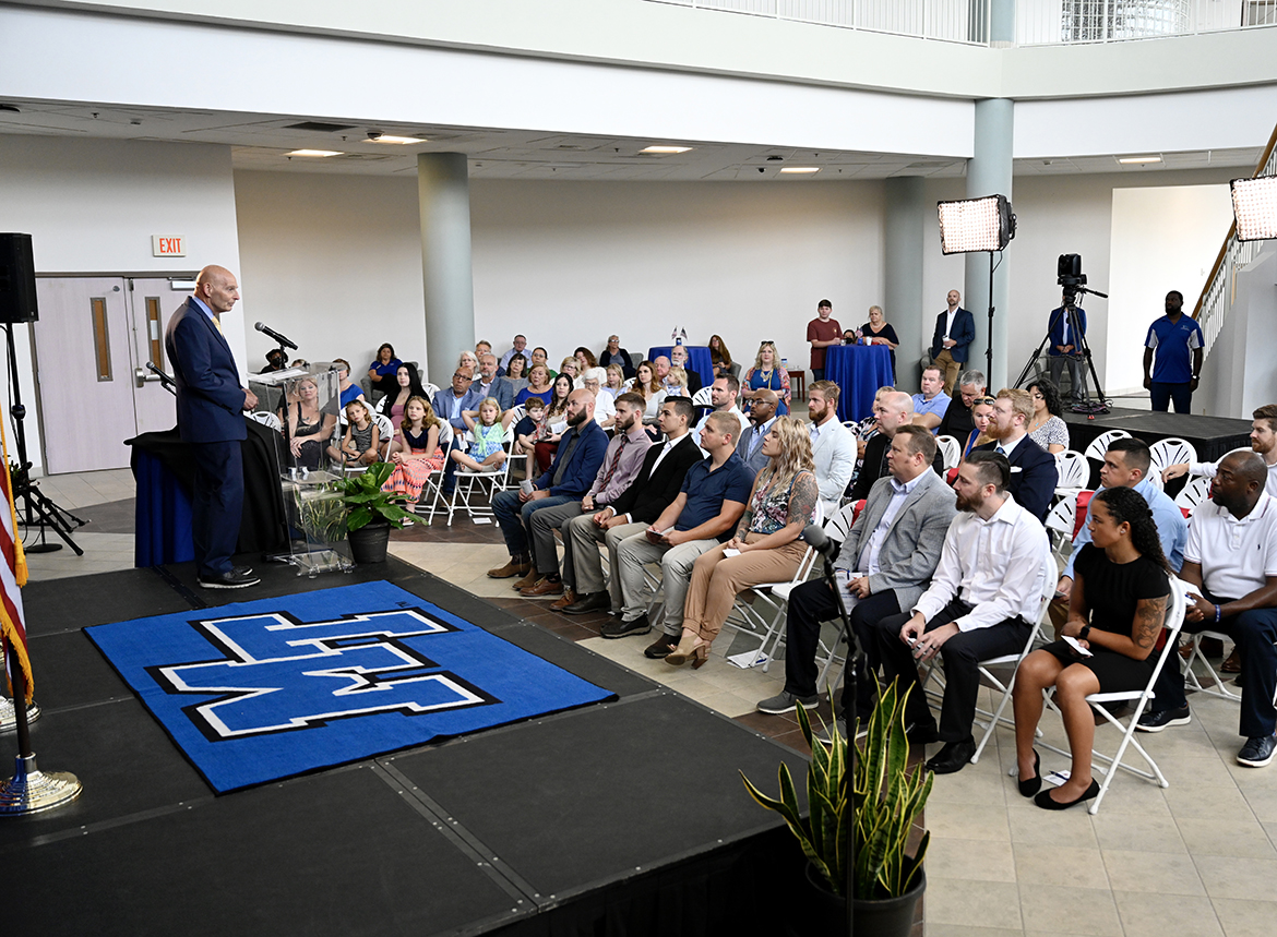 Keith M. Huber, left, MTSU senior adviser for veterans and leadership initiatives and retired U.S. Army lieutenant general, addresses the audience Wednesday, July 27, during the summer Graduating Veterans Stole Ceremony in the Miller Education Center second-floor atrium. Twenty student veterans, who will be graduating from the university at 9 a.m. Saturday, Aug. 6, in Murphy Center, participated in the ceremony, held in the Miller Education Center second-floor atrium. (MTSU photo by J. Intintoli)