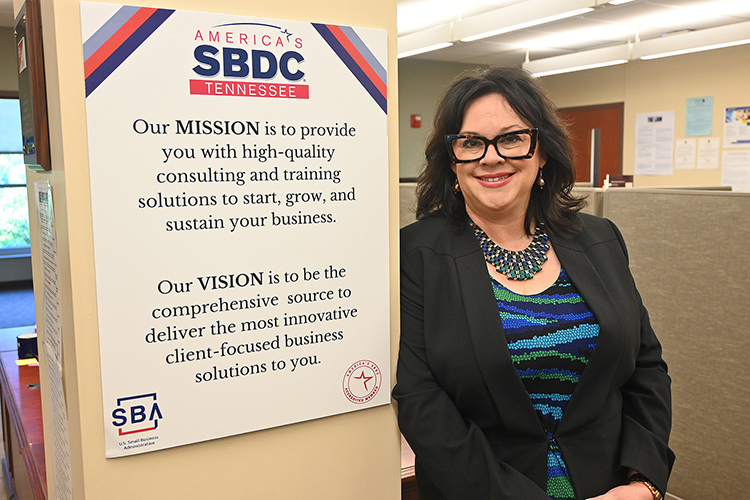 MTSU alumna Amelia Bozeman, shown here next to the mission and vision statements of the Tennessee Small Business Development Center in the TSBDC’s Murfreesboro office inside the Rutherford County Chamber of Commerce. Bozeman became director of the TSBDC Murfreesboro Service Center in January and wants to spread the word about the suite of consultation and training resources to business owners and entrepreneurs available through the center. (MTSU photo by Jimmy Hart)