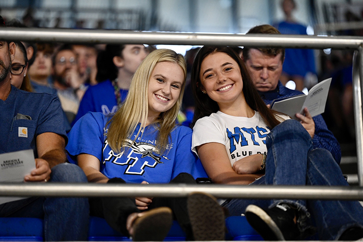 Clad in their MTSU-branded T-shirts, two young attendees are all smiles at the 2022 University Convocation for new freshmen and transfer students at Murphy Center Aug. 21.