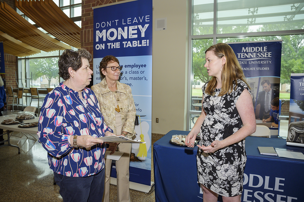 Lori Sultzer, left, MTSU Post Office manager Lori Sultzer, left, and Psychology Department secretary Sandra Campbell learn about opportunities for employees to take classes at the university from Sarah Hendrix, manager of Strategic Communications in the College of Graduate Studies, recently in the Student Union first-floor atrium. The university held an event recently to promote the special employee benefit. (MTSU photo by Andy Heidt)