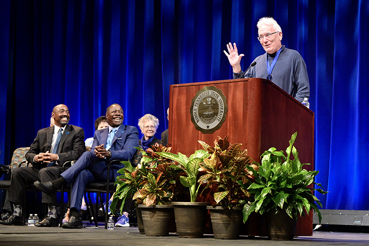 MTSU psychology professor Thomas Brinthaupt gives remarks after receiving the MTSU Foundation's Career Achievement Award Thursday, Aug. 18, during the university’s Fall Faculty Meeting inside Tucker Theatre. Seated at left in front are MTSU Foundation President Ronald Roberts, far left, and MTSU President Sidney A. McPhee.  (MTSU photo by Andy Heidt)