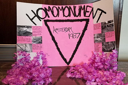This MTSU student poster from the 2018 Holocaust Studies Conference exhibit explains the Homomonument, a memorial erected in 1987 in Amsterdam, The Netherlands. It was the first monument to gay men and lesbians who were persecuted and killed by the Nazis for their sexual orientation. The pink triangle represents a cloth badge that Nazis forced LGBTQ individuals to wear.
