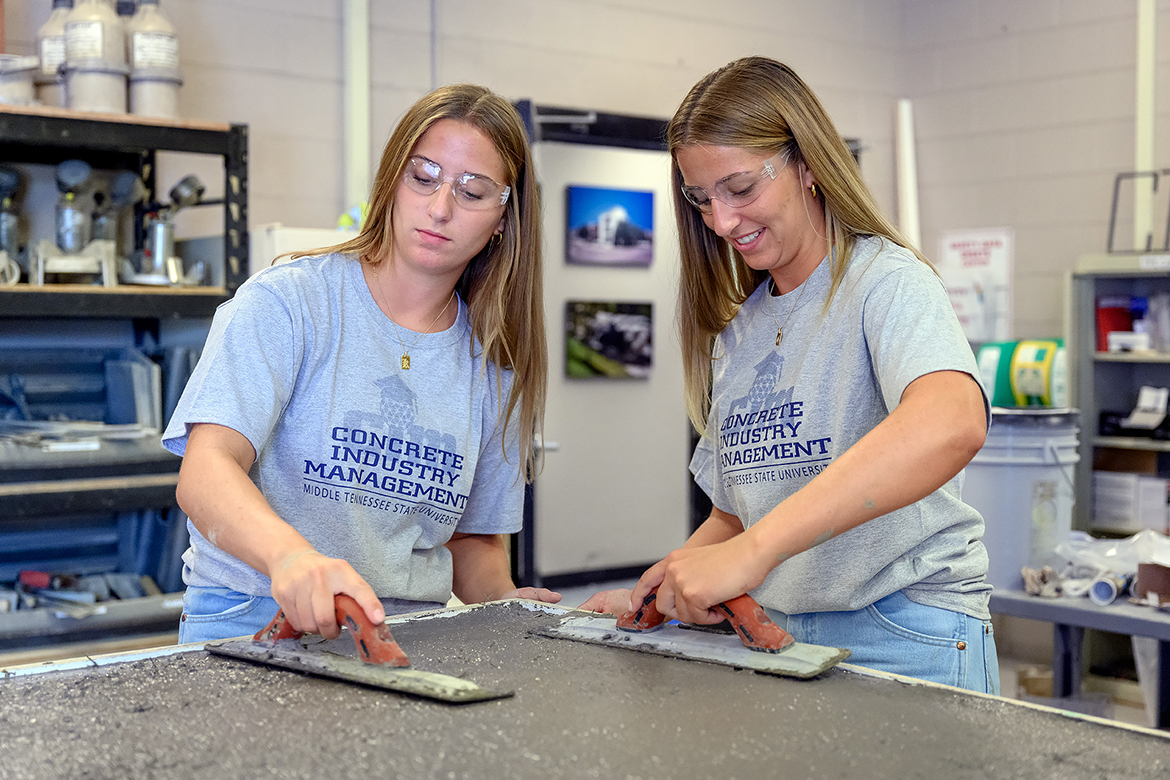 MTSU concrete industry students Ashley, left, and Kayla Gates work on a project with high-fiber concrete in the lab recently. They will take the panel to Nashville Friday, Aug. 5, and will talk about their NASA-related minority research and the CIM program at the race track outside Nissan Stadium. (MTSU photo by J. Intintoli)