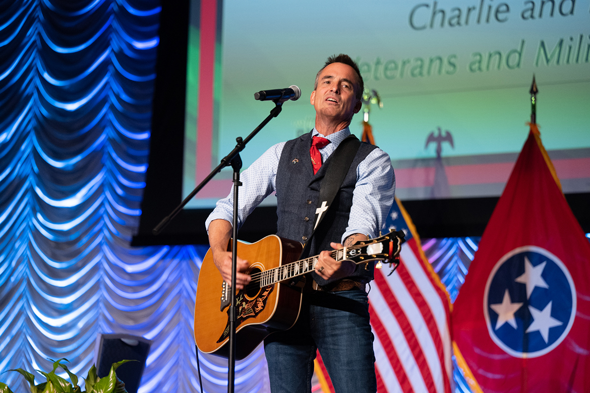 Combat veteran and entertainer Keni Thomas performs the song, "Not Me," to wrap up his one-hour storytelling and music performance Thursday, Aug. 25, during the fifth annual Veteran Impact Celebration at MTSU in the Student Union Ballroom. A recipient of a Bronze Star for valor and American Patriot Award, Thomas was part of special operations in Somalia in 1993. (MTSU photo by James Cessna)
