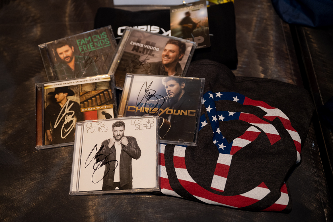 CDs and T-shirts provided by former MTSU student and country music star Chris Young were part of the numerous auction items up for bid from people attending the fifth annual Veteran Impact Celebration Thursday, Aug. 25, in the Student Union Ballroom at MTSU. Thousands of dollars from auction proceeds will benefit the Charlie and Hazel Daniels Veterans and Military Family Center at MTSU. (MTSU photo by James Cessna)