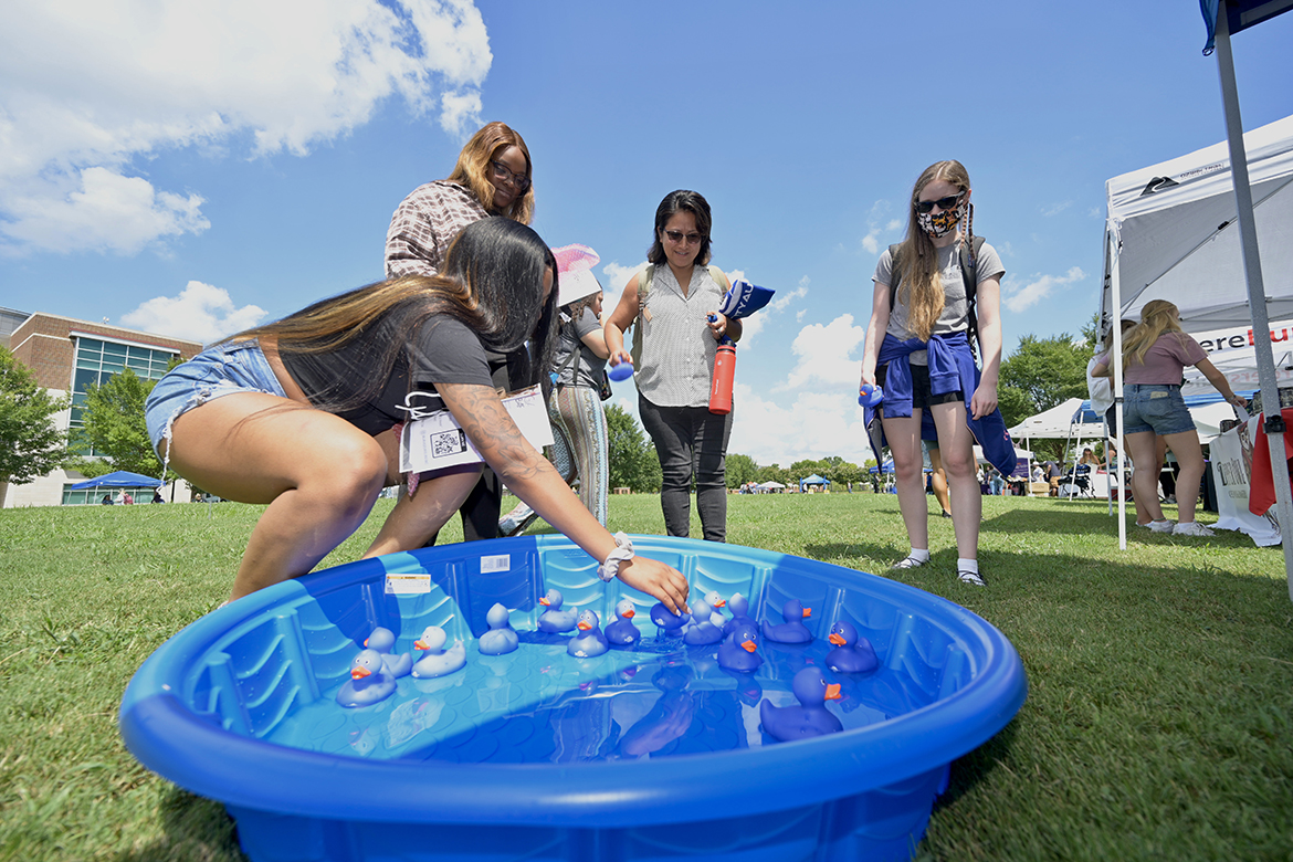 MTSU student Mariah Higgenbottom, left, a child development and family studies major from Memphis, Tenn., senior biology major Kennedy Harper of Memphis, junior business administration major Alma Spivey of Murfreesboro and Alayna Root, a junior biology major from Thompson’s Station, Tenn., take turns pulling a rubber duck out of the child’s pool to see if they won a prize during Meet Murfreesboro Tuesday, Aug. 23, in the Student Union Commons. The event continues from 10 a.m. to 2 p.m. Wednesday, Aug. 24. (MTSU photo by Andy Heidt)