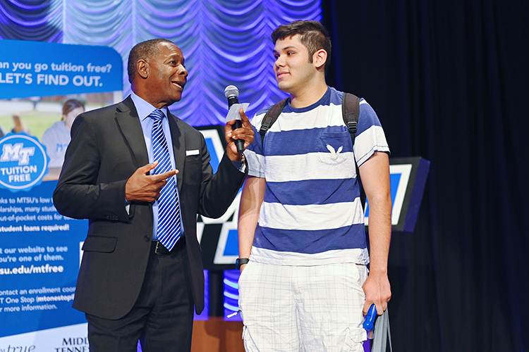 Henry Bello, prospective Middle Tennessee State University student interested in studying computer science, shares the microphone with University President Sidney A. McPhee after winning a $22,000 scholarship during the university’s kickoff event for the True Blue Tour at the Student Union Building on campus Wednesday, Aug. 17, 2022. (MTSU photo by Cat Curtis Murphy)