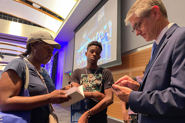 Greg Van Patten, right, dean of the Middle Tennessee State University College of Basic and Applied Sciences, talks with prospective MTSU student Justin Adams, center, and his mother during the kickoff event for the university’s True Blue Tour at the Student Union Building in mid-August. (MTSU file photo by Randy Weiler) 