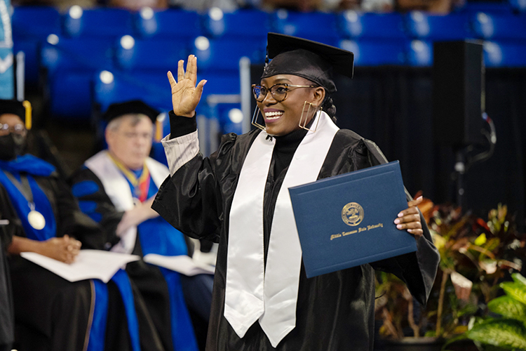 Newly minted MTSU College of Behavioral and Health Sciences graduate Maryrose Uwimana holds her degree with excitement after crossing the stage at Murphy Center Saturday, Aug. 6, at the university's summer commencement ceremony. MTSU presented 857 degrees to undergrad and graduate students during the event, which concludes the university's 111th academic year. (MTSU photo by James Cessna)