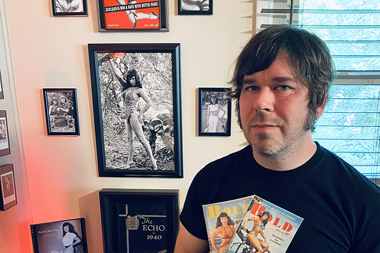 Ben Wilkinson, Middle Tennessee State University history alumnus, poses here with his personal Bettie Page memorabilia after recently securing a Nashville historical marker for the pinup icon, which will be placed at her alma mater Hume-Fogg Academic High School in Nashville, Tenn., later this year or early next. (Photo courtesy of Ben Wilkinson)