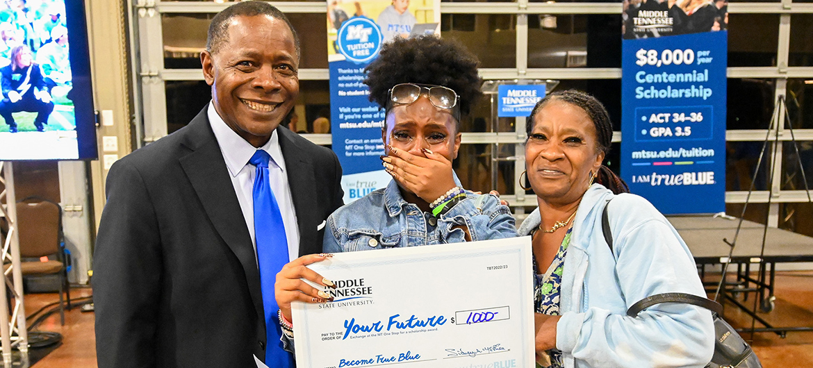 Prospective Middle Tennessee State University student Olivia Porter, center, is overcome with emotion along with her grandmother Cardella Reed-Smith after being awarded a surprise scholarship from University President Sidney A. McPhee, left, at MTSU’s True Blue Tour event at the Wilma Rudolph Event Center in Clarksville, Tennessee, on Wednesday, Sept. 28, 2022. (MTSU photo by Stephanie Wagner)
