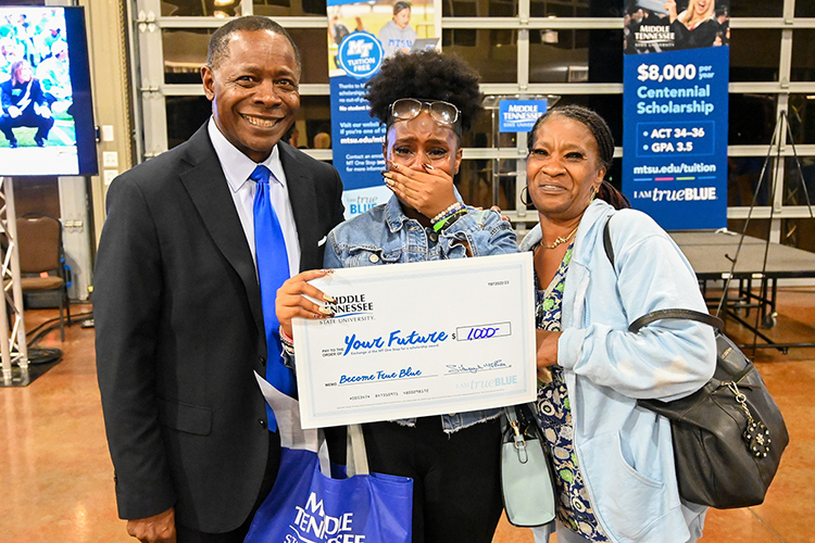 Prospective Middle Tennessee State University student Olivia Porter, center, is overcome with emotion along with her grandmother Cardella Reed-Smith after being awarded a surprise scholarship from University President Sidney A. McPhee, left, at MTSU’s True Blue Tour event at the Wilma Rudolph Event Center in Clarksville, Tennessee, on Wednesday, Sept. 28, 2022. (MTSU photo by Stephanie Wagner)