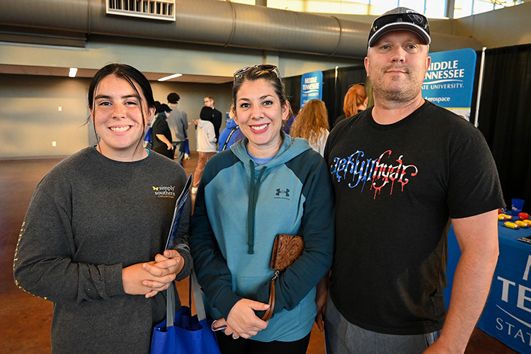 Prospective Middle Tennessee State University student Daisy Guzman, left, checks out the MTSU True Blue Tour recruitment event with her parents, Rusty Guzman-Bowe, center, and Ben Bowe on the recommendation of her guidance counselors on Wednesday, Sept. 28, 2022, at the Wilma Rudolph Event Center in Clarksville, Tennessee. (MTSU photo by Stephanie Wagner)