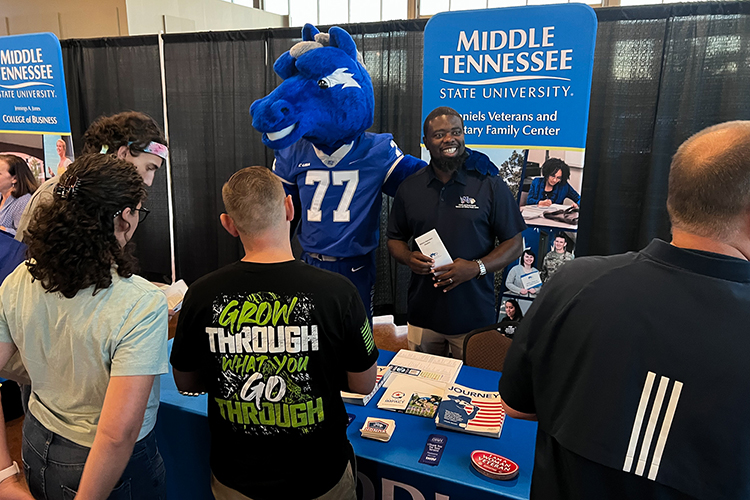 Prospective Middle Tennessee State University students and their families visit Christopher Rochelle, assistant director of the Charlie and Hazel Daniels Veterans and Military Family Center, and MTSU mascot Lightning at the university’s True Blue Tour event on Wednesday, Sept. 28, 2022, at the Wilma Rudolph Event Center in Clarksville, Tennessee. (MTSU photo by Andrew Oppmann)