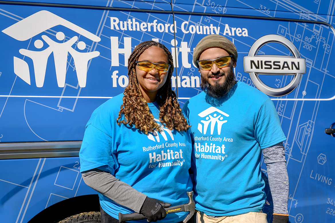 Future homeowners Arionna "Ari" Robinson Alcocer, left, a 2018 graduate of MTSU, and husband Eduardo "Eddie" Alcocer take a break from the Habitat Panel Build Sept. 29 in the MTSU Student Union Commons. They joined dozens of volunteers helping to build the home they hope will be ready by April 1, 2023. (MTSU photo by J. Intintoli)