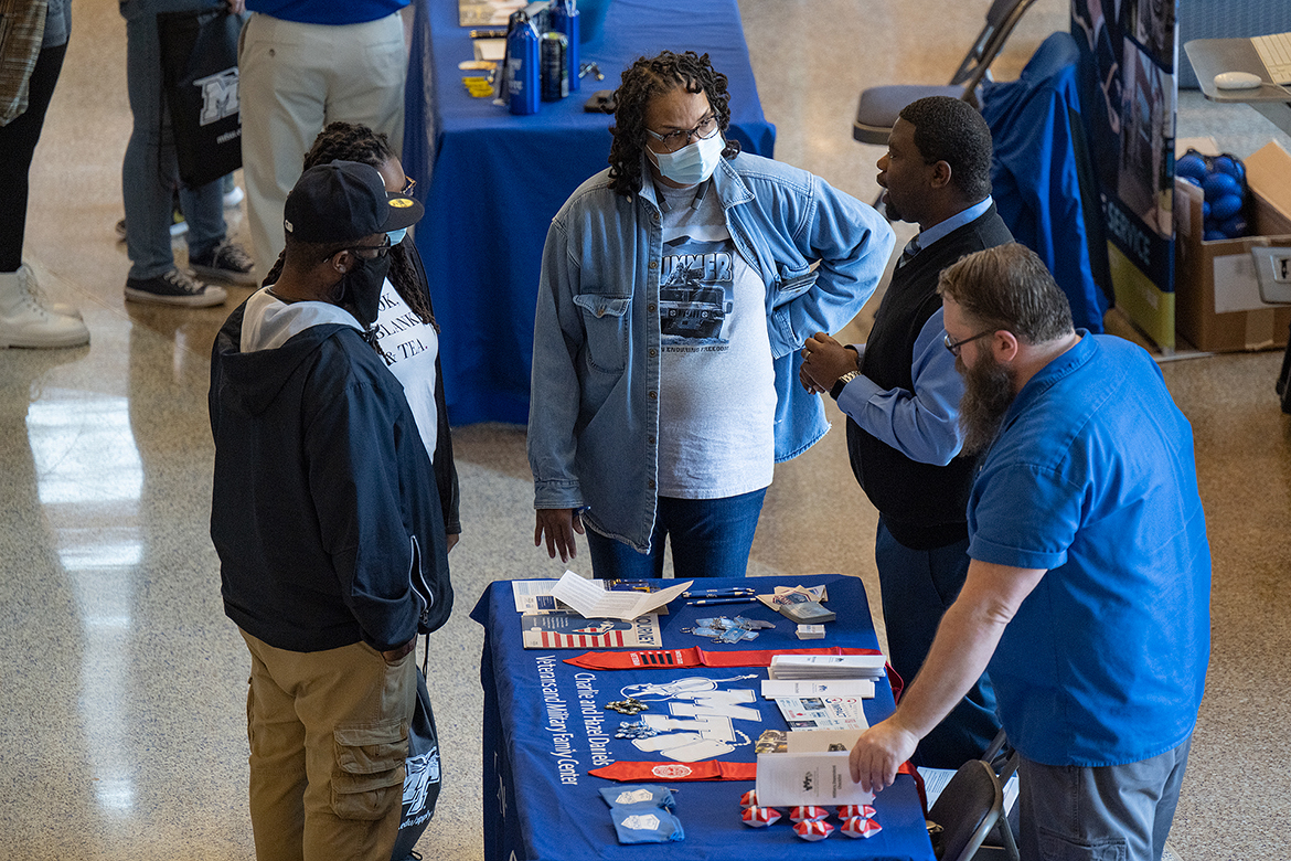 During the spring True Blue Preview in the Student Union Building in late March, a visiting family listens as MTSU Daniels Veterans Center staff members Chris Rochelle, second from right, and Jeremy Winsett, right, share about benefits available to student veterans. MTSU admissions and numerous other departments host Saturday preview events on Oct. 1 and Nov. 5. (MTSU file photo by Cat Curtis Murphy)