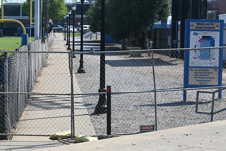 Fencing has been erected to close access to the sidewalk that runs between the football practice fields and the Reese Smith Baseball Field and Stadium as a safety precaution while a major infrastructure project is completed throughout the fall semester. Detour signage has been posted to direct pedestrians to an alternative route to reach the campus interior. (MTSU photo by Jimmy Hart)