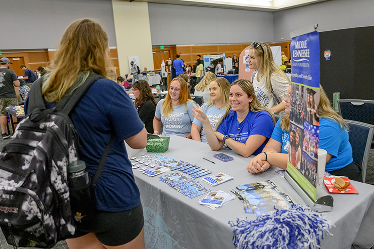 MTSU student Rylee Fancher, center right, with MTSU Fraternity and Sorority Life, talks to a student during the annual MTSU Student Organization Fair held Aug. 30 in the Student Union Ballroom. Students had the chance to meet members of more than 100 student organizations participating in the fair, which attracted hundreds of students during breaks between classes.  The Center for Student Involvement and Leadership held the fair at a central location and time where the university’s more than 300 clubs and groups can recruit new members. (MTSU photo by J. Intintoli)