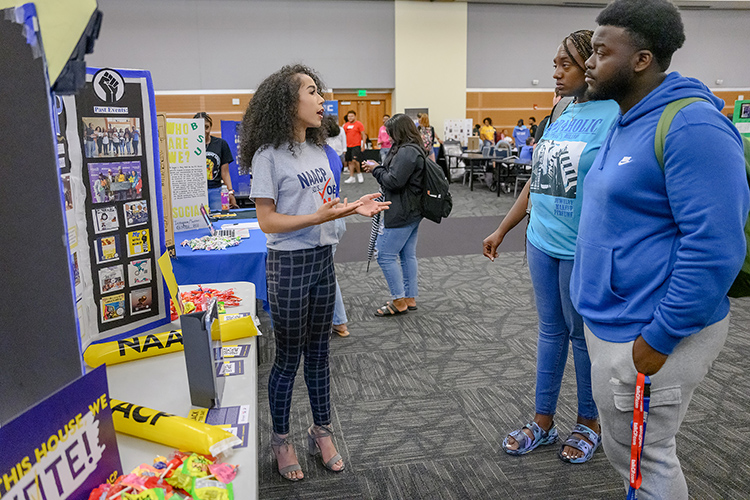 MTSU NAACP Student Chapter President Paige Jackson, left, talks to students who stopped by the group's table during the annual MTSU Student Organization Fair held Aug. 30 in the Student Union Ballroom. (MTSU photo by J. Intintoli)