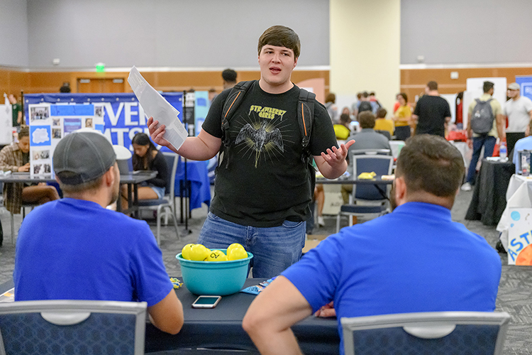 MTSU student John Martin talks to representatives of the Belle Aire College Ministry during the annual MTSU Student Organization Fair held Aug. 30 in the Student Union Ballroom. (MTSU photo by J. Intintoli)