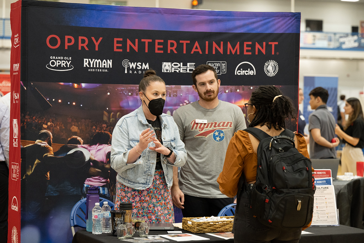 Representatives from Opry Entertainment speak an MTSU student during the 2022 Fall Career Fair held Sept. 29 in the Campus Recreation Center. (MTSU photo by James Cessna)