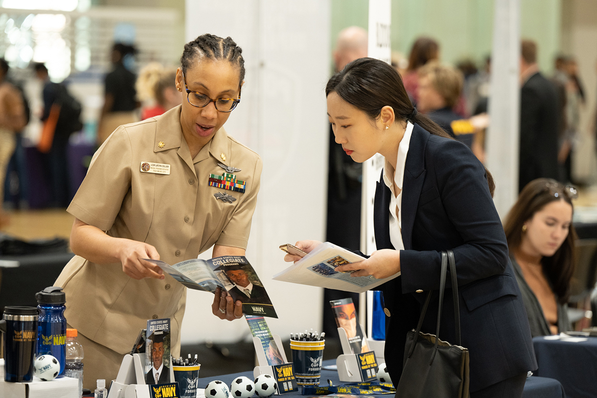 MTSU student Lara Park, right, a senior nutrition and food science/wellness major from Daejeon, South Korea, speaks with a U.S. Navy representative during the 2022 Fall Career Fair held Sept. 29 in the Campus Recreation Center. (MTSU photo by James Cessna)