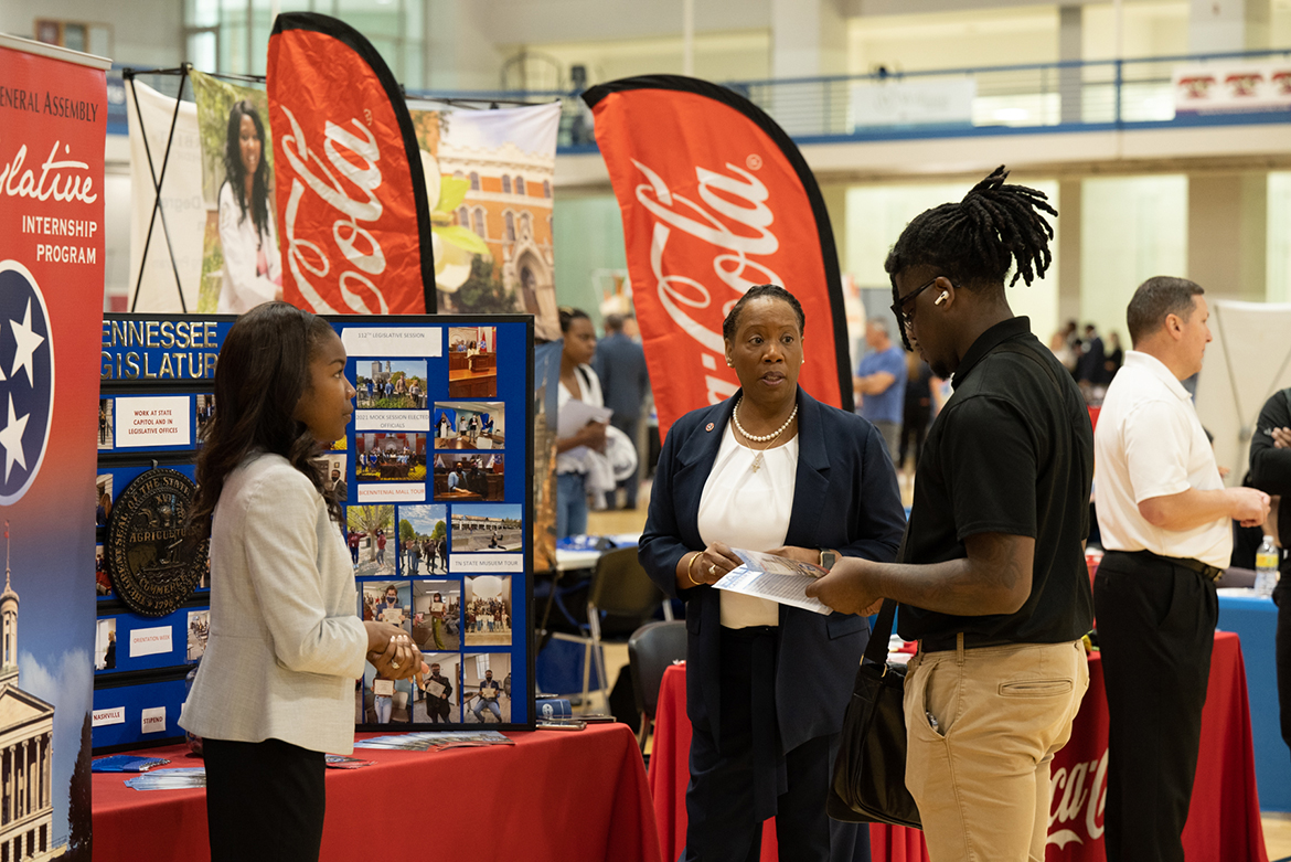 Representatives from the Coca-Cola company speak with a student during the 2022 Fall Career Fair held Sept. 29 in the Campus Recreation Center. (MTSU photo by James Cessna)