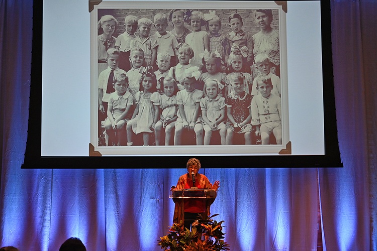 Child Holocaust survivor Sonja Dubois of Knoxville, Tenn., discusses an early school photo from her childhood living in Holland during her Sept. 23 talk to close out the university’s 14th biennial Holocaust Studies Conference in the MTSU Student Union Ballroom. Dubois notes that she, bottom row, second from left, stood out with her dark, curly locks among the mostly blond Dutch children. (MTSU photo by Jimmy Hart)