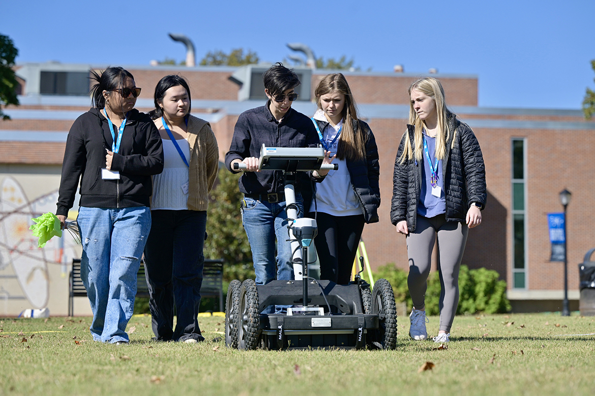 Riverdale High School Honors College students, from left, Lina Nguyen, Katie Nguyen, Lexy Williams and Libby Lyles observe a demonstration of the ground-penetrating radar machine by Clelie Peacock outdoors Thursday, Oct. 20, during their visit to campus. The MTSU College of Basic and Applied Sciences organized the event. (MTSU photo by Andy Heidt)