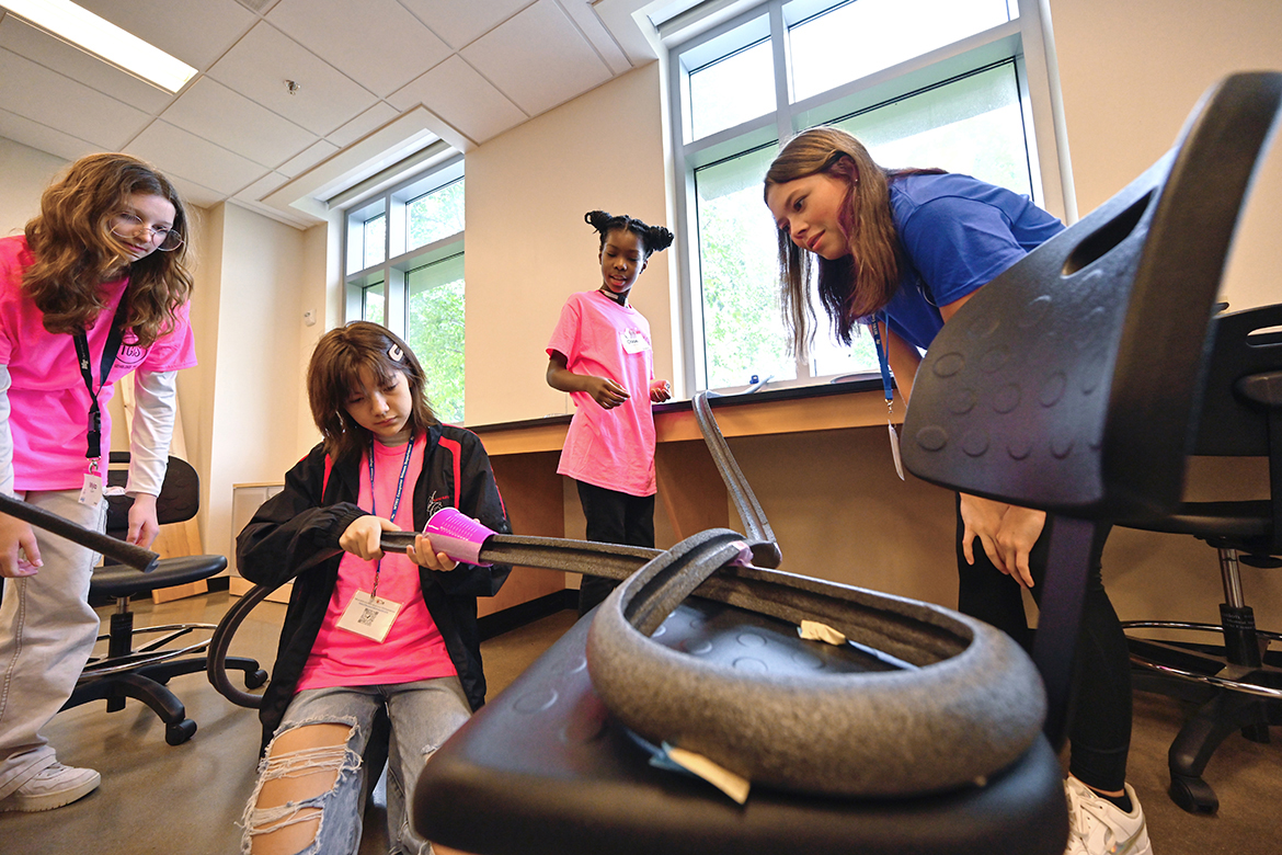 Middle School girls build a marble roller coaster — one of the activities they and high school girls pursued during the 26th annual Tennessee Girls in STEM math and science conference at MTSU, held Sept. 24. MTSU freshman mechatronics engineering major Alexus Cox, right, of Maryville, Tenn., watches as Myla Smith, left, of Murfreesboro and a Blackman Middle School student, Tiffany Trader of Smyrna, Tenn., and Stewarts Creek Middle School and Chloe Johnston of Hendersonville and Hawkins Middle School make track adjustments. (MTSU photo by Cat Curtis Murphy)