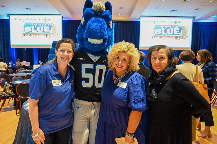 Middle Tennessee State University College of Education professors Heather Dillard, left, Shannon Harmon, center, and Pam Ertel pose with MTSU mascot Lightning during the inaugural Teacher Appreciation celebration they organized to honor local teachers from Rutherford County Schools and Murfreesboro City Schools, at the James Union Building on campus on Sept. 27, 2022. (MTSU photo by Stephanie Wagner)