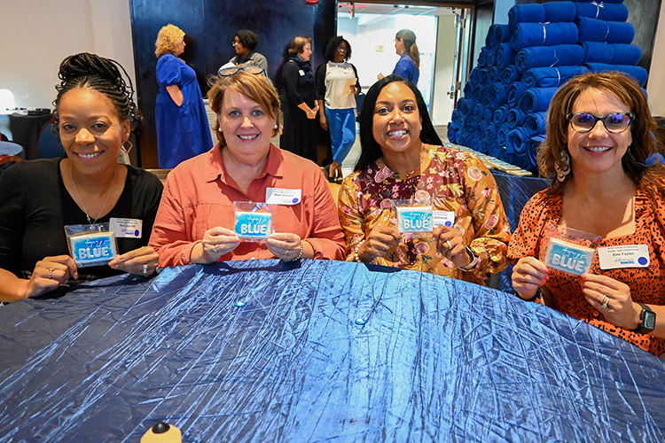 From left, local teachers Maryam Hill, Sheri Arnette, Maria Johnson and Kim Taylor hold up their “True Blue” Middle Tennessee State University-themed cookies at the Teacher Appreciation event for teachers from Rutherford County Schools and Murfreesboro City Schools put on by the school’s College of Education on Sept. 27, 2022, at the James Union Building on campus. (MTSU photo by Stephanie Wagner)