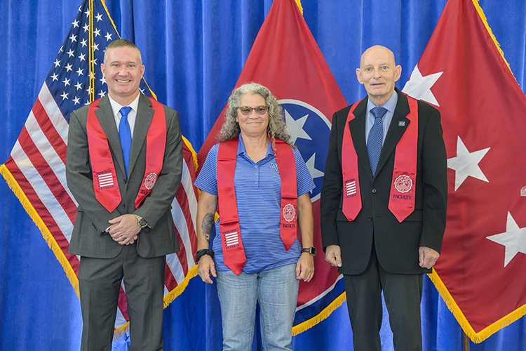 U.S. Army Reserve veteran Betty Miller, center, who works in the MTSU Post Office, wears her red stole received during the Faculty/Staff Stole Ceremony held Nov. 9 at the Miller Education Center. Pictured with her are retired Lt. Gen. Keith Huber, right, senior adviser for veterans and leadership initiatives, and U.S. Army veteran Lee Wade, ceremony speaker and interim associate dean for the College of Behavioral and Health Science. (MTSU photo by Andy Heidt)