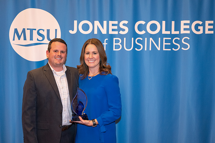 Middle Tennessee State University alumna Megan Bynum, right, holds the Young Professional of the Year Award she received earlier during a special reception for 2022 Leadership Summit award recipients hosted by the Jennings A. Jones College of Business on Oct. 27, 2022, at Embassy Suites in Murfreesboro, Tenn. Pictured with her is husband Wesley Bynum. (MTSU photo by Cat Curtis Murphy)