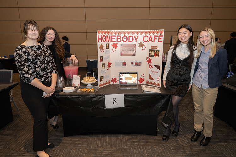 High school students Jenna Glass, Ava Rossello, Sydney Hurt and Bella Spry from Middle Tennessee Christian School in Murfreesboro, Tenn., pose with the display for their business concept Homebody Café during MTSU’s seventh High School Entrepreneurship Fair held Nov. 16 in the Student Union Ballroom. The students captured the second place award for their business concept. (MTSU photo by James Cessna)
