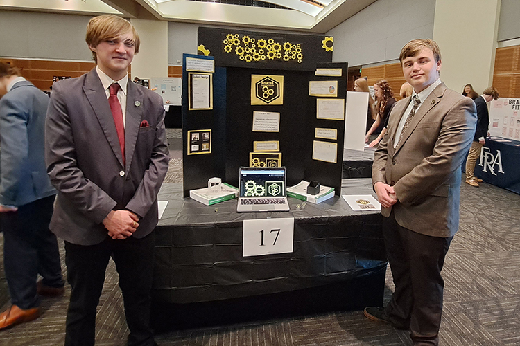High school freshmen Hunter Higgs, left, and Wyatt Petelle of Murfreesboro’s Central Magnet School stand with their display for EngiTex during MTSU’s seventh High School Entrepreneurship Fair held Nov. 16 in the Student Union Ballroom. The students earned the Engineering Enterprise Award for the business concept. (MTSU photo by Jimmy Hart)