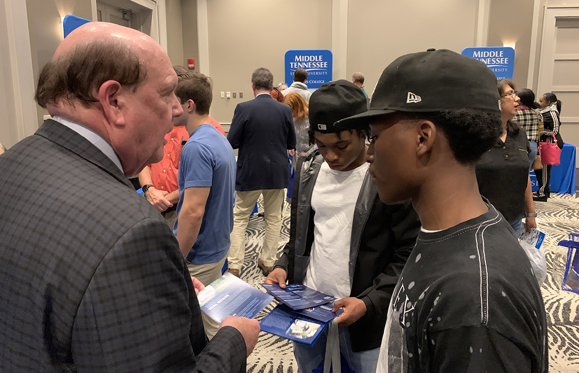 MTSU Jennings A. Jones College of Business Dean David Urban, left, shares information about his college with two prospective students attending the Memphis True Blue Tour event Tuesday, Nov. 8, at Esplande Memphis in Cordova, Tenn. (MTSU photo by Randy Weiler)