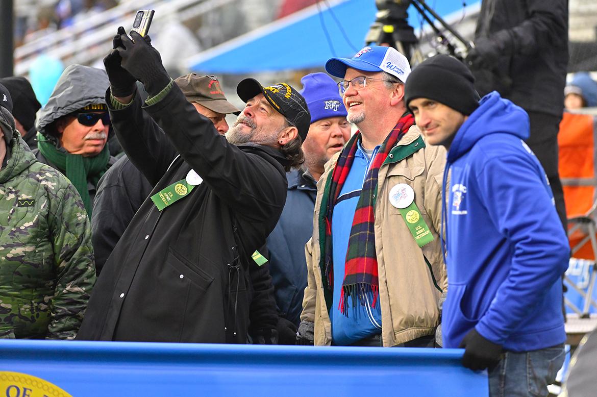 A U.S. Army veteran takes a selfie of he and his Army veterans with his cell phone in Floyd Stadium on Saturday, Nov. 12. The MT Blue Raiders defeated visiting Charlotte 49ers 24-14 in a Conference USA game. Salute to Veterans game activities were hosted by MT Athletics and the Charlie and Hazel Daniels Veterans and Military Family Center. (MTSU photo by Cat Curtis Murphy)
