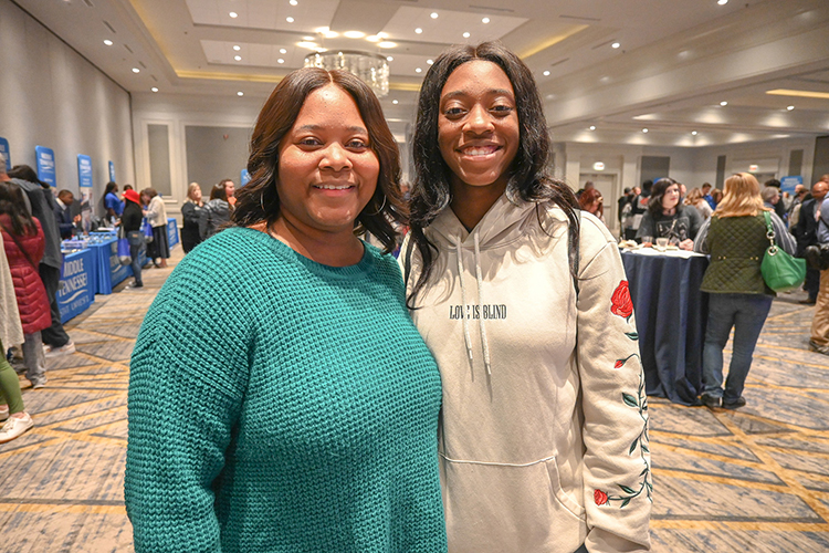Keviyah Endsley, senior at Siegel High School in Murfreesboro, Tenn., right, visits the Middle Tennessee State University True Blue Tour event at the Cool Springs Marriott in Franklin, Tenn., on Monday, Nov. 14, 2022, with her mom, Natasha Endsley, and talks with MTSU advisors about biology programs. (MTSU photo by Stephanie Wagner)